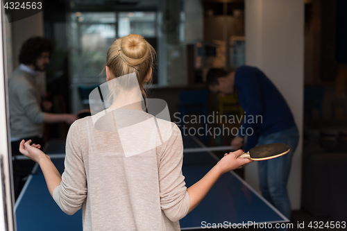 Image of startup business team playing ping pong tennis