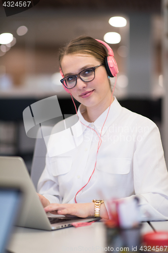 Image of businesswoman using a laptop in startup office