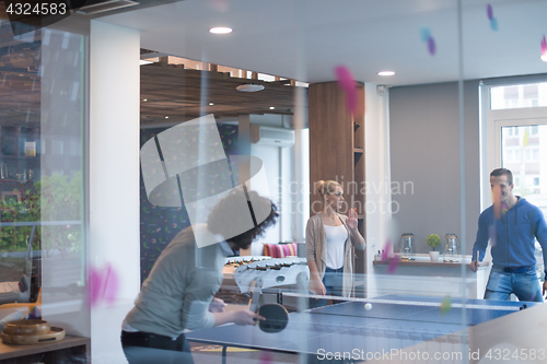 Image of startup business team playing ping pong tennis