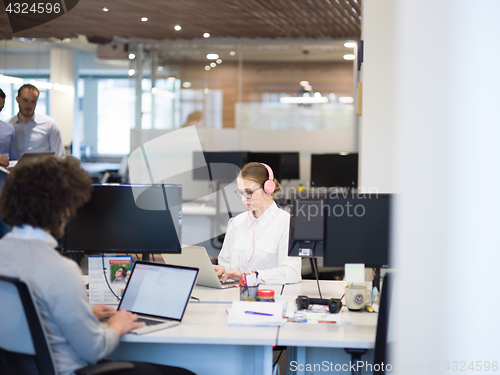 Image of businesswoman using a laptop in startup office