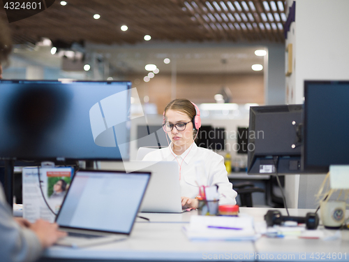 Image of businesswoman using a laptop in startup office