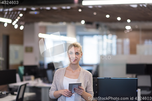 Image of Business Woman Using Digital Tablet in front of startup Office