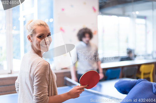 Image of startup business team playing ping pong tennis