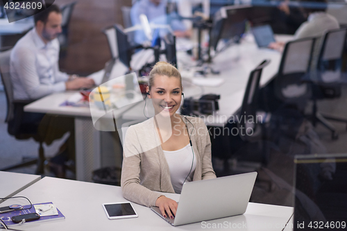 Image of businesswoman using a laptop in startup office