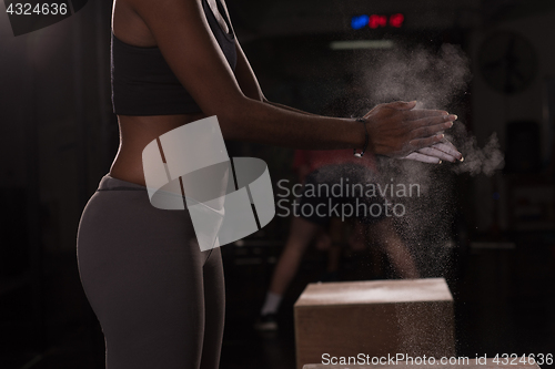 Image of black woman preparing for climbing workout