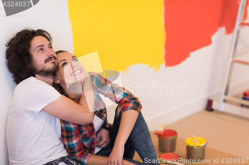 Image of Happy young couple relaxing after painting