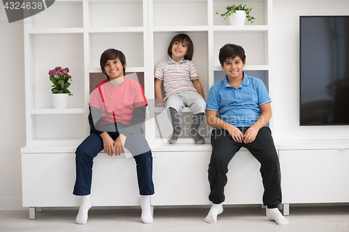 Image of young boys posing on a shelf