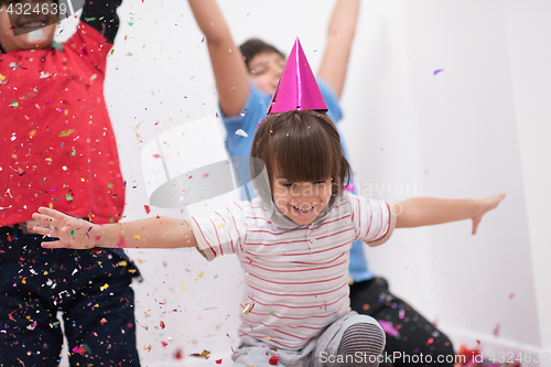 Image of kids  blowing confetti