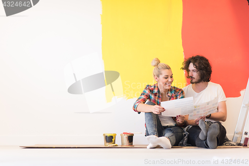 Image of Happy young couple relaxing after painting