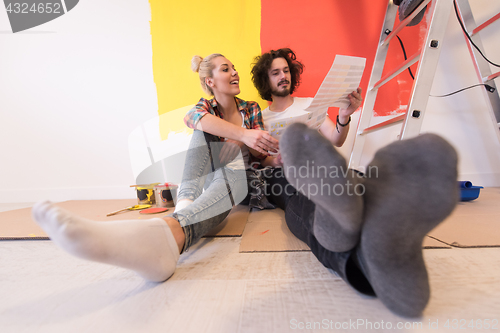 Image of Happy young couple relaxing after painting