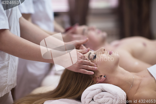 Image of couple enjoying head massage at the spa