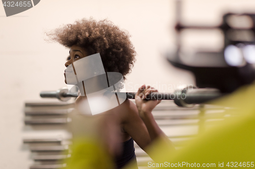 Image of black woman lifting empty bar