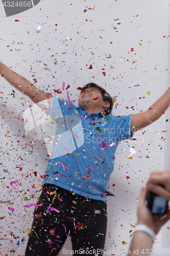 Image of kid blowing confetti