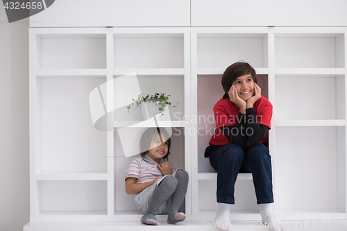 Image of young boys posing on a shelf