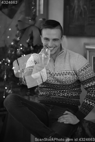 Image of Happy young man with a glass of champagne