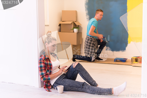 Image of couple doing home renovations