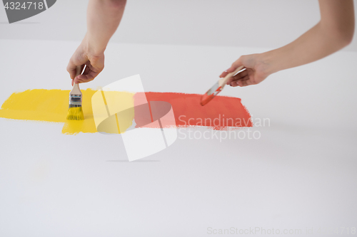 Image of couple painting interior wall