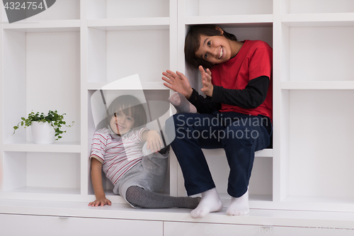 Image of young boys posing on a shelf