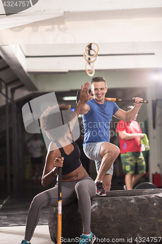 Image of multiethnic couple after workout with hammer