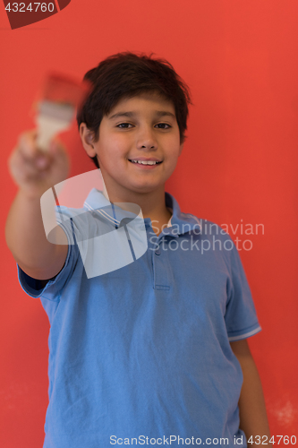 Image of Portrait of a happy young boy painter