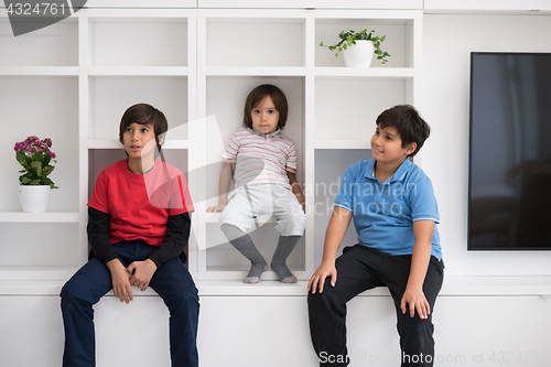 Image of young boys posing on a shelf