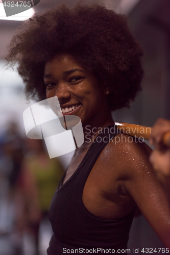 Image of black woman lifting empty bar