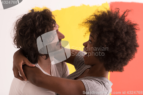 Image of Young happy multiethnic couple hugging