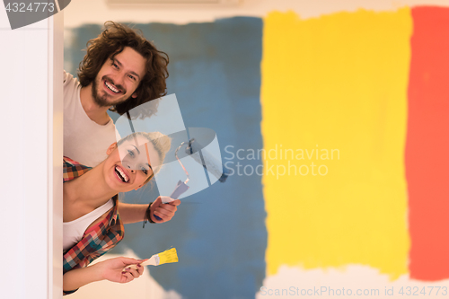 Image of portrait of a couple painting interior wall