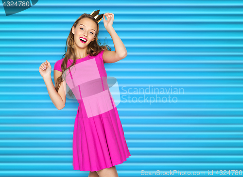 Image of happy young woman or teen girl in pink dress