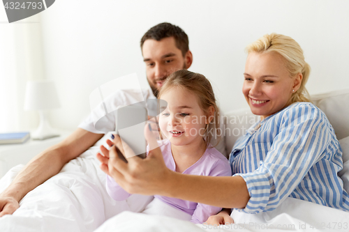 Image of happy family with  smartphone at home