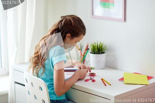 Image of happy girl making something at home