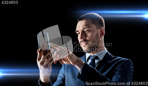 Image of businessman with transparent smartphone