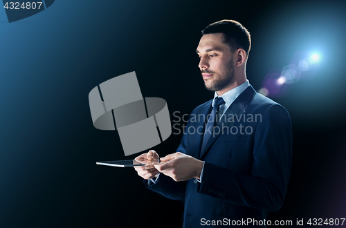 Image of businessman in suit with transparent tablet pc