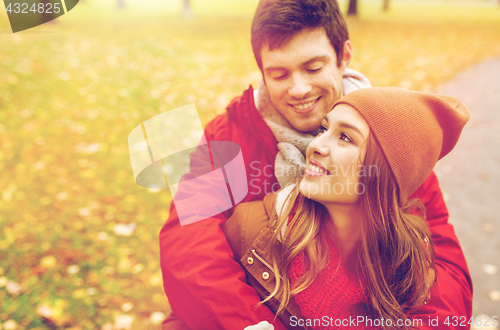 Image of happy young couple hugging in autumn park