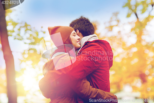 Image of happy young couple hugging in autumn park