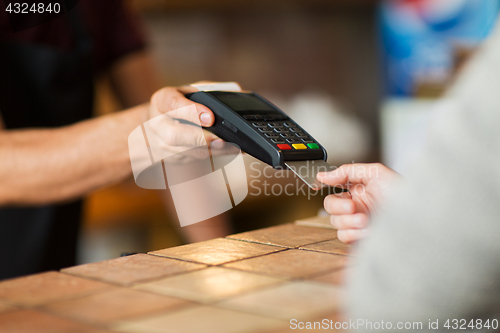 Image of hands with payment terminal and credit card