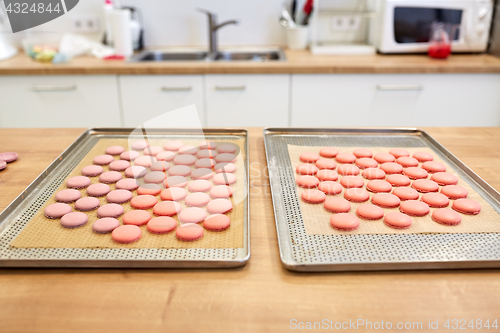 Image of macarons on oven trays at confectionery