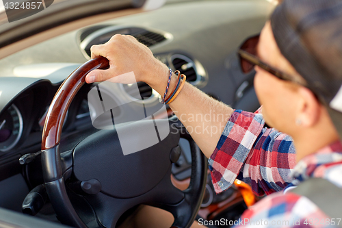 Image of close up of happy man driving car