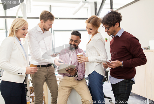 Image of business team with tablet pc and coffee at office