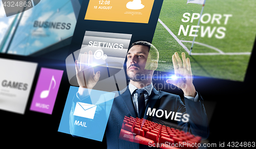 Image of businessman with applications on virtual screen