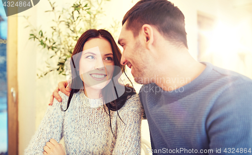 Image of happy couple hugging at cafe or restaurant