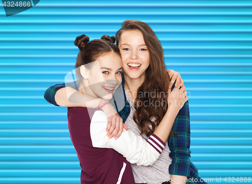 Image of happy smiling pretty teenage girls hugging