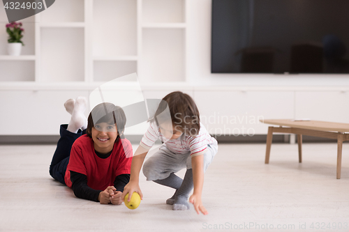 Image of boys having fun with an apple on the floor