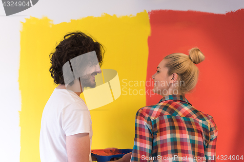 Image of couple painting interior wall