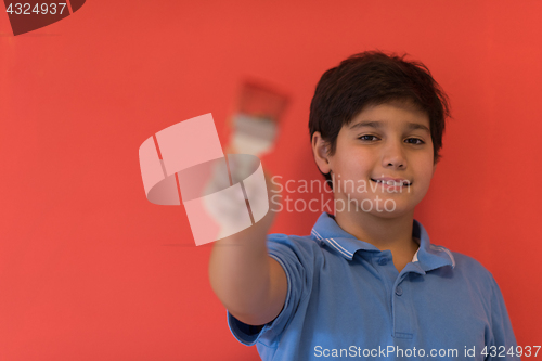 Image of Portrait of a happy young boy painter