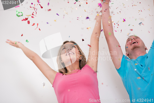 Image of romantic young  couple celebrating  party with confetti