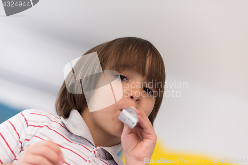 Image of kid blowing a noisemaker