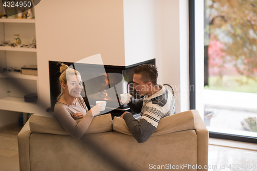 Image of Young couple  in front of fireplace