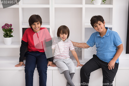 Image of young boys posing on a shelf