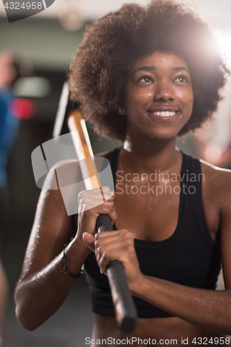 Image of black woman after workout with hammer